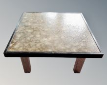 A 20th century tiled topped coffee table on metal legs