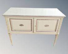 A 20th century painted double door serving cabinet on raised legs