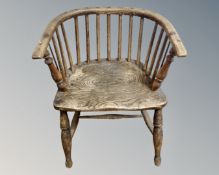 A 19th century elm Windsor low-back armchair.