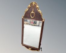 An antique wood framed wall mirror with gilt decoration.
