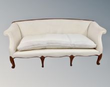 A Regency style low back settee upholstered in cream fabric