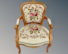 A carved beech framed salon armchair in tapestry fabric