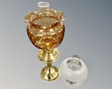 A Victorian style brass based paraffin lamp with tinted glass shade and further glass shade with