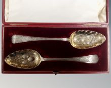A pair of cased silver berry spoons, London marks.