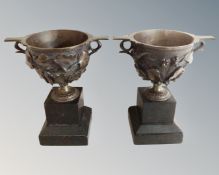 A pair of bronze urns on black slate, bases, height 21cm.