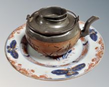 A vintage Chinese wood and pewter teapot together with a further antique porcelain plate decorated