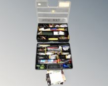 Two multi-compartment storage boxes containing fishing equipment including telescopic rod, floats,