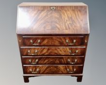 A reproduction mahogany fall front bureau fitted with four drawers beneath.