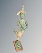 A patinated metal figure of a Thai dancer, height 68cm, on wooden stand.