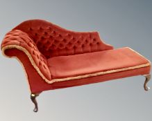 A chaise longue upholstered in a buttoned dralon.