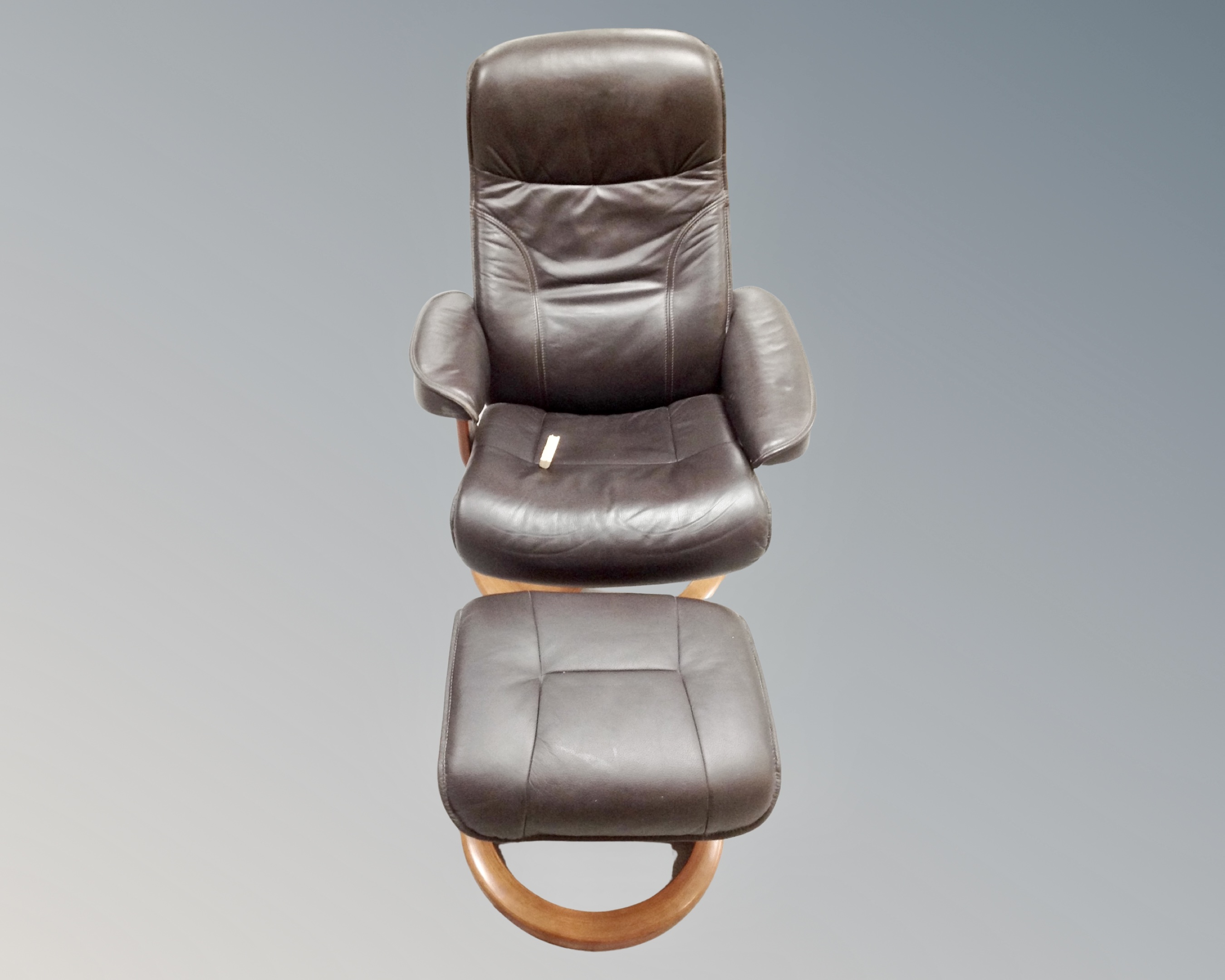 A brown leather reclining lounger chair with stool (arm damaged)