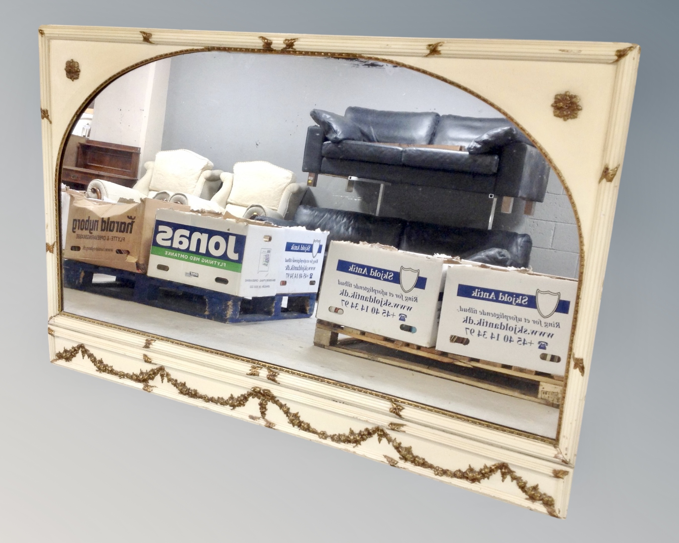 A cream and gilt framed mirror