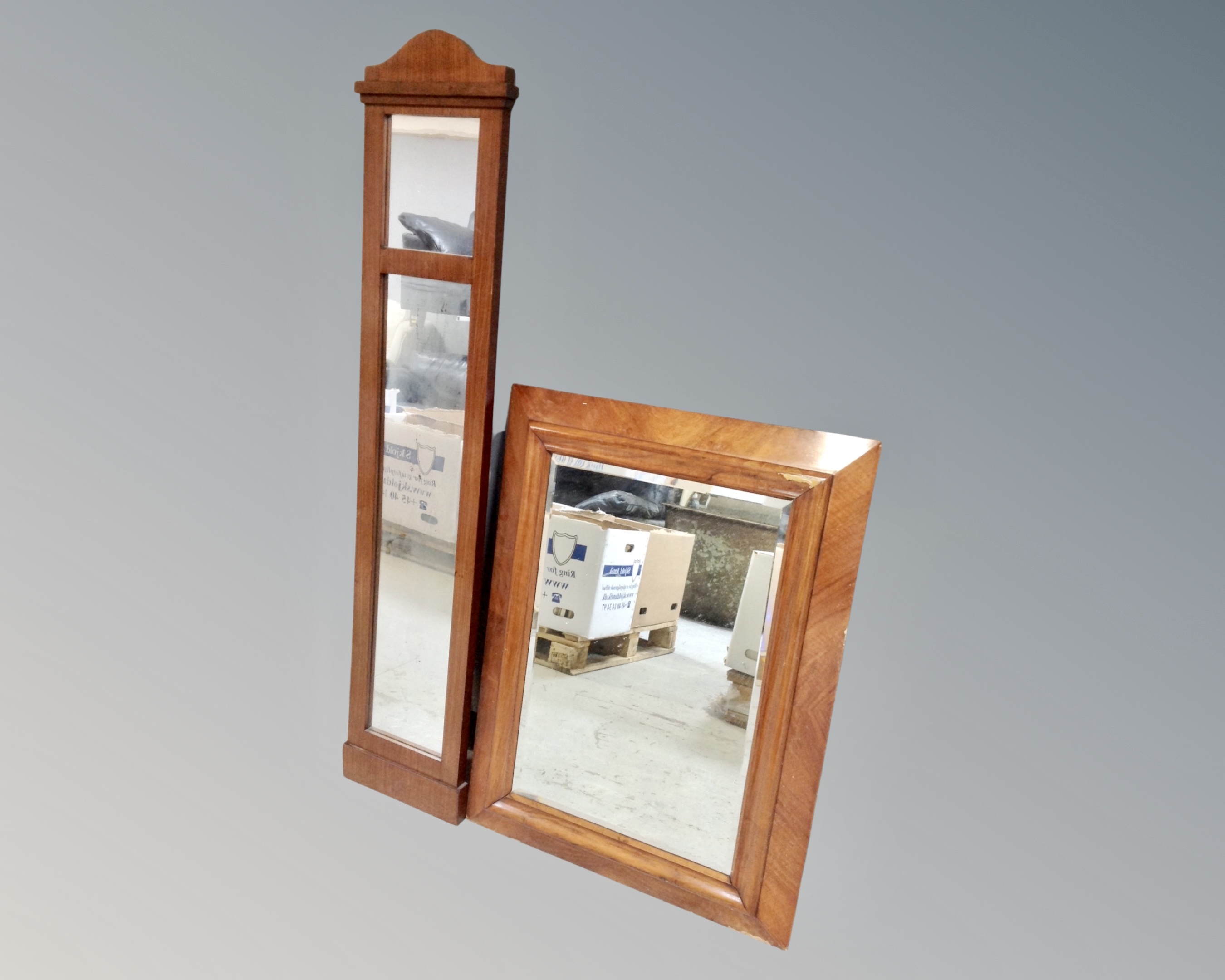 An antique mahogany bevel edged wall mirror together with a further mahogany hall mirror.