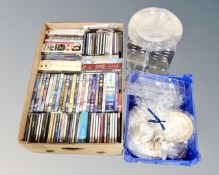 A box of CDs, DVDs, Jane Austen collection, part tea set, display stand.