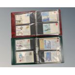 Two Avon stamp albums containing a total of 124 First Day Covers.