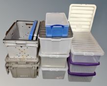 A quantity of plastic tote boxes and storage boxes with lids.