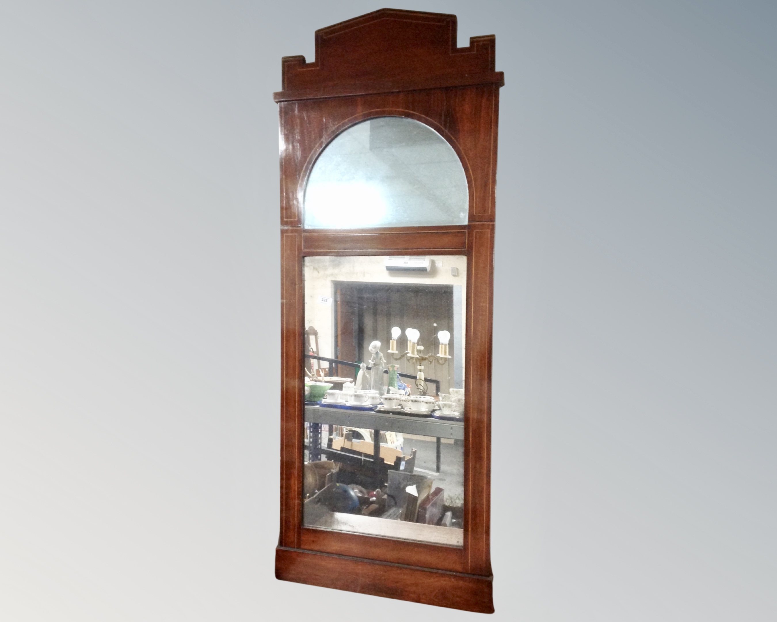 A continental inlaid mahogany wall mirror.