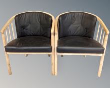 A pair of open beech framed tub chairs with black leather cushions