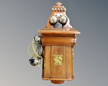 A continental mahogany bell wall telephone.
