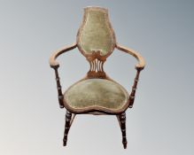 An Art Nouveau open armchair with heart shaped seat.