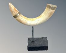 A resin 'hippo tusk' on stand.
