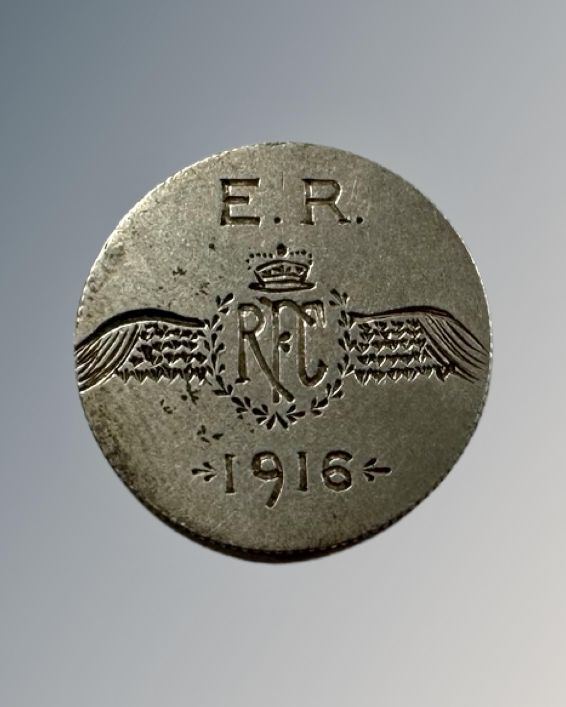 A coin inscribed E R Royal Flying Corps 1916