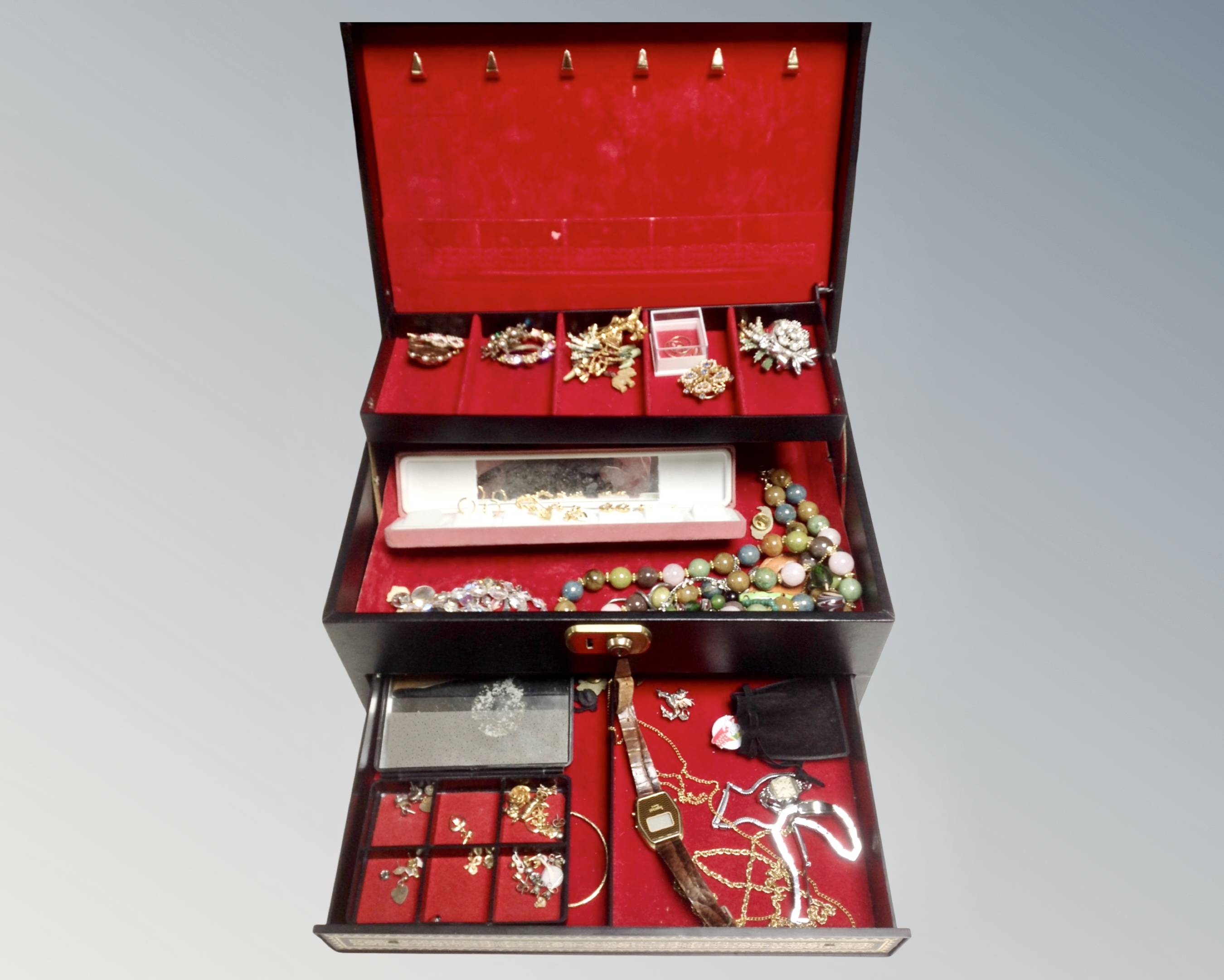 A contemporary lift out jewelry box contain costume beads, lady's wristwatches, earnings, broaches,