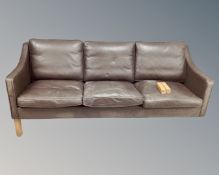 A 20th century Danish Hurup brown leather three seater settee (three legs currently loose)