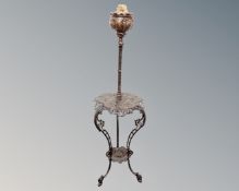 An antique ornate cast iron rise and fall oil lamp table