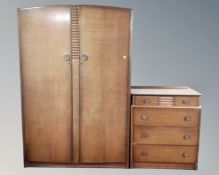 A mid century four piece bedroom suite comprising double door wardrobe, four drawer chest,