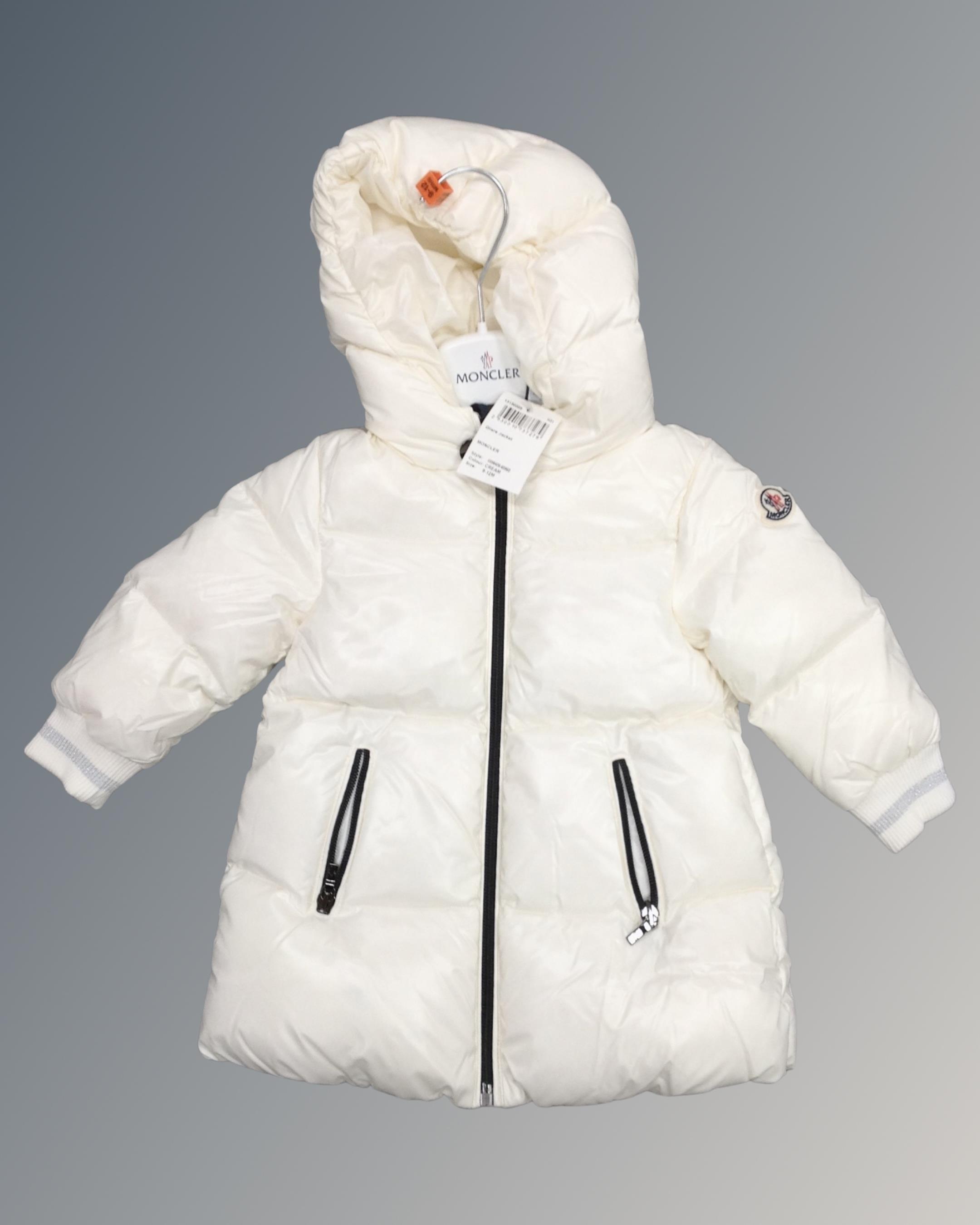 A Moncler gilet jacket, cream, size 9-12 months, tagged and new.