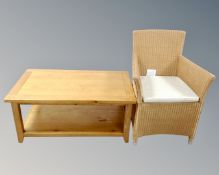 A contemporary oak two tier coffee table together with a wicker armchair