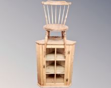 An antique pine hanging corner cupboard together with an Ibex kitchen chair