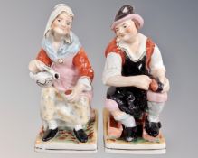 A pair of Staffordshire seated figures