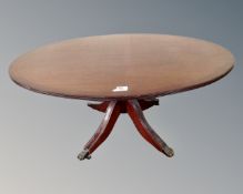 An inlaid mahogany oval low table