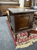 An Edwardian mahogany cabinet on raised legs