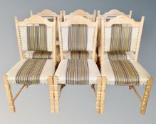 A set of six Continental light oak dining chairs in striped fabric