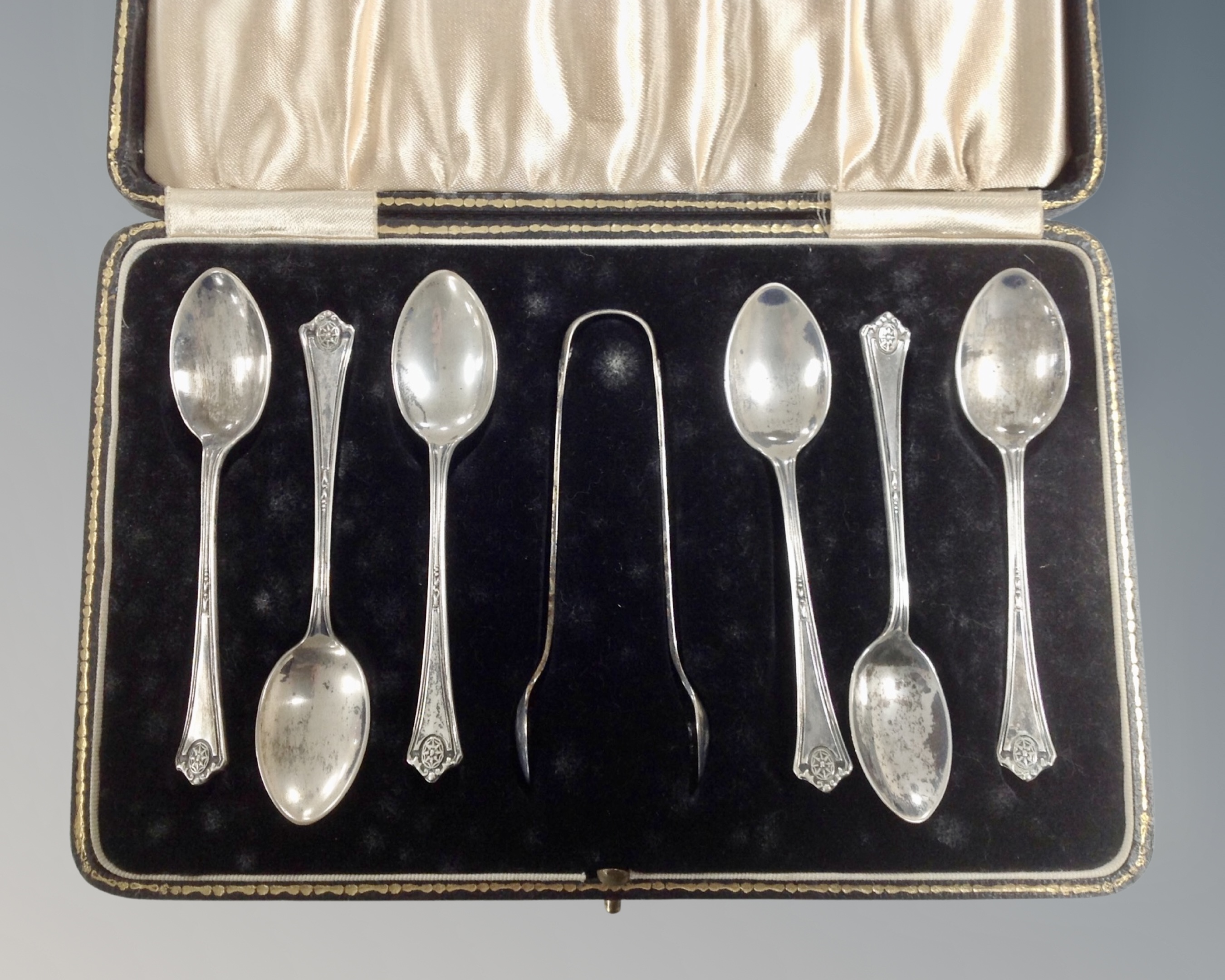 A set of six Birmingham silver teaspoons with sugar tongs, cased.
