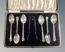 A set of six Birmingham silver teaspoons with sugar tongs, cased.