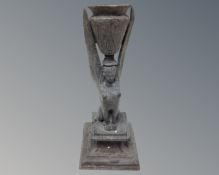 An antique pewter Egyptian style candlestick