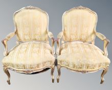 A pair of Continental gilded armchairs upholstered in golden two-tone fabric