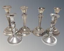 A pair of chrome barley twist candlesticks together with two further pairs of silver plated