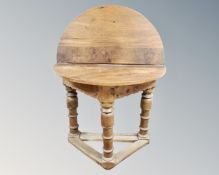A 19th century oak demi-lune turn over top table