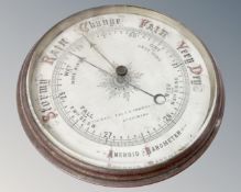 A Victorian aneroid barometer with enamelled dial