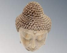A carved wooden head of Buddha, height 20cm.