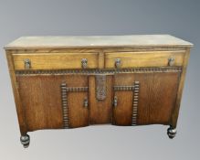 A 1930's oak double door sideboard