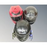 Three motorcycle helmets together with two motorcycle toys