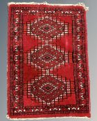 A small Afghan hearth rug 66 cm x 46 cm