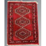 A small Afghan hearth rug 66 cm x 46 cm