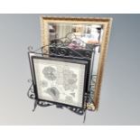 A gilt framed bevelled mirror together with a wrought iron framed needle work fire screen